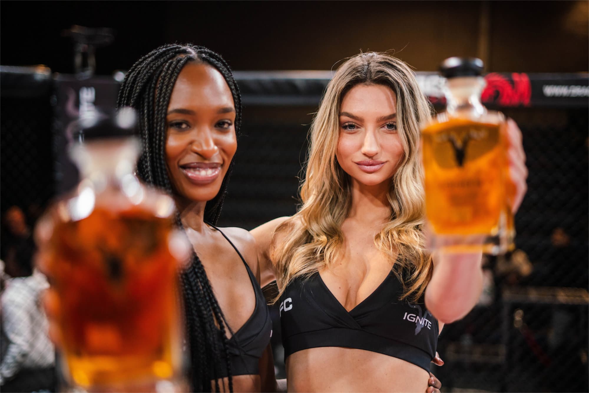 EFC ring girls holding drinks in the octagon