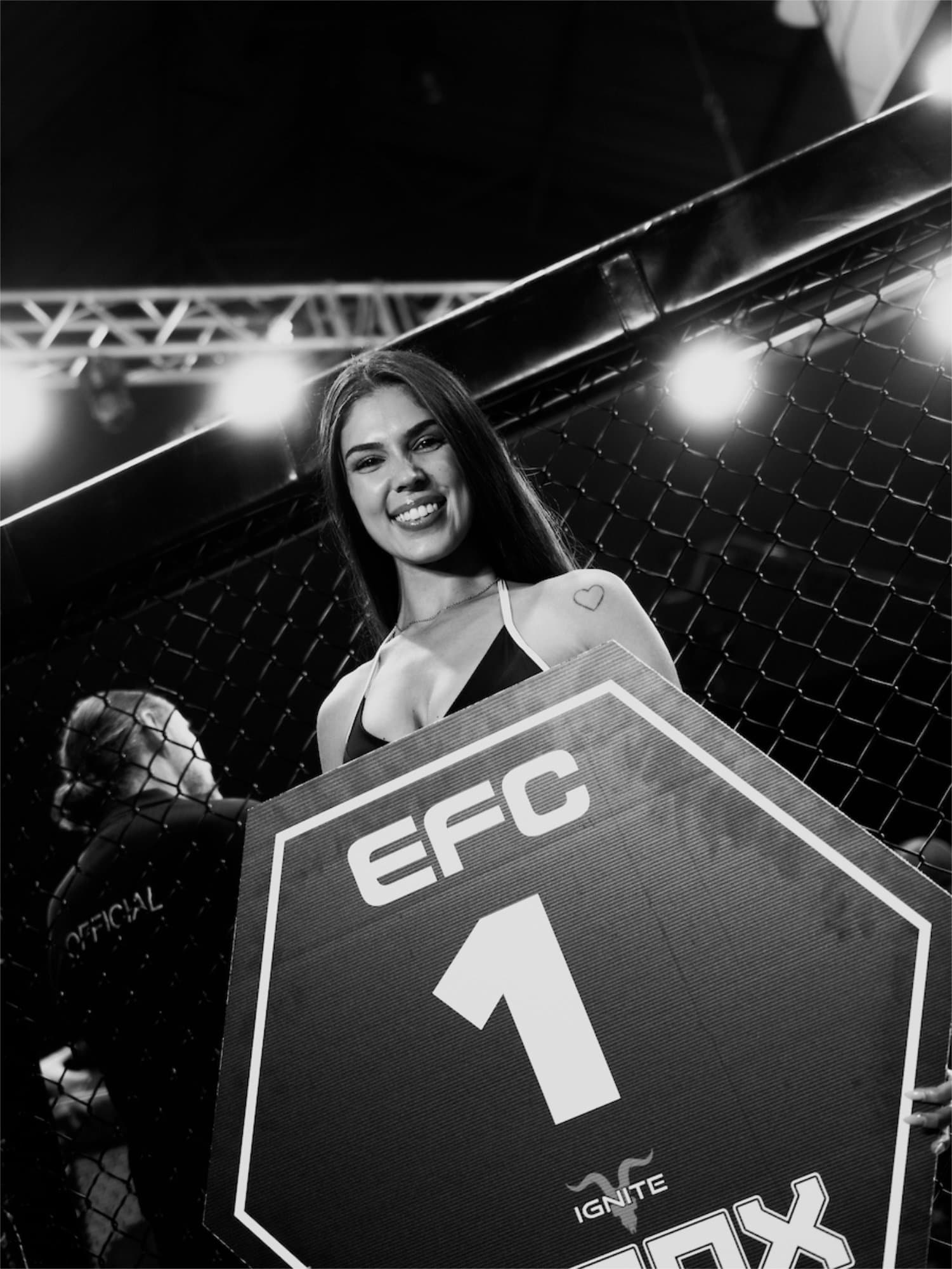 EFC ring girl with round card inside the octagon