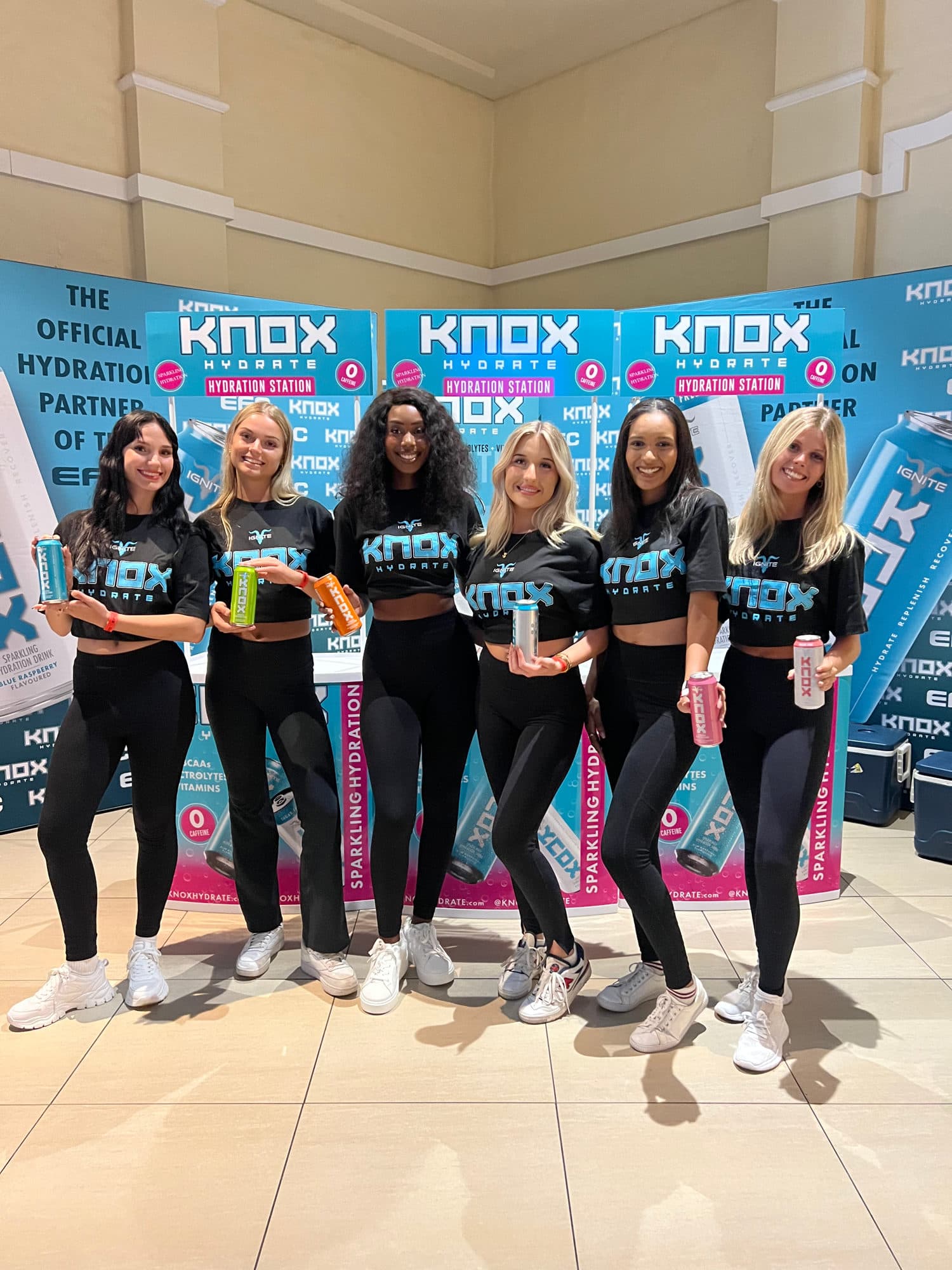 Knox Hydration ambassadors holding product at an EFC event