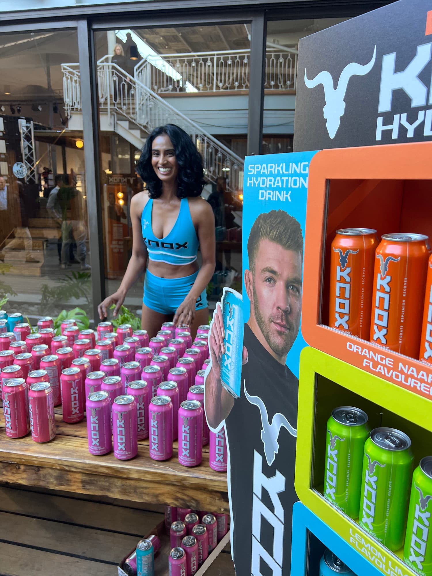 Knox Hydration ambassador at a sampling stand with product display