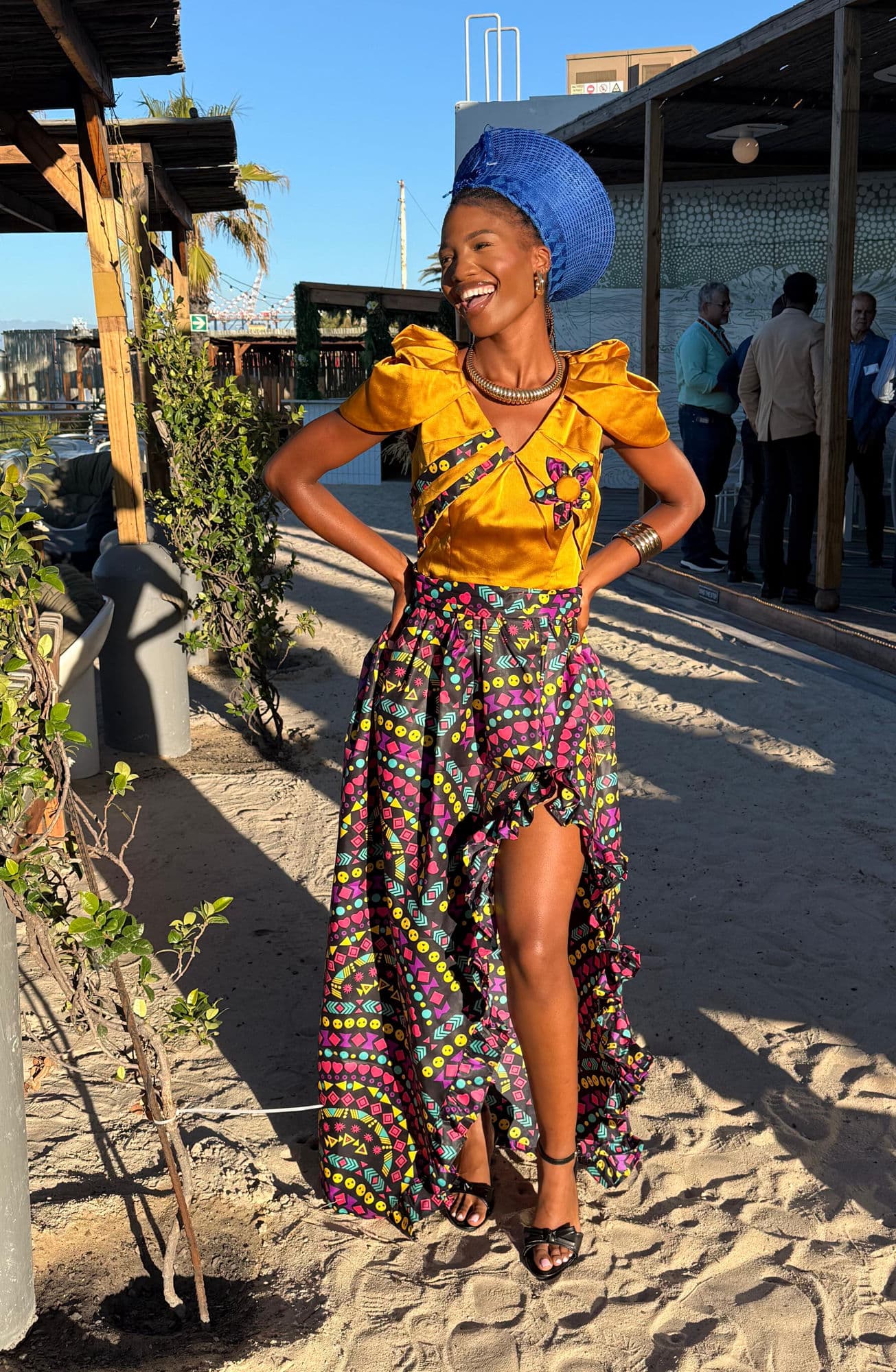 Entertainment performer in traditional African attire at a beach venue